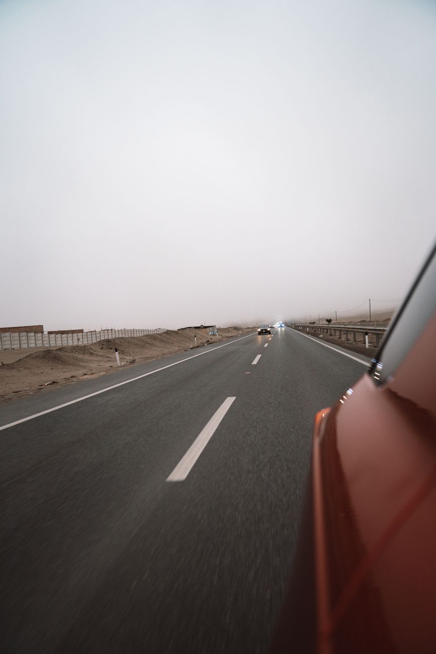 Open desert highway illustrating the guided tours versus self-driving travel debate
